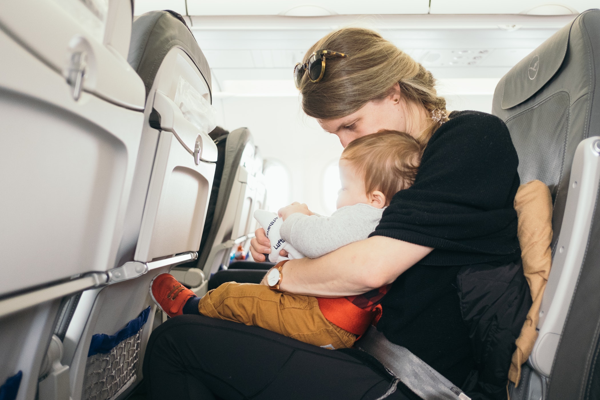 Mother holding her child on a plane