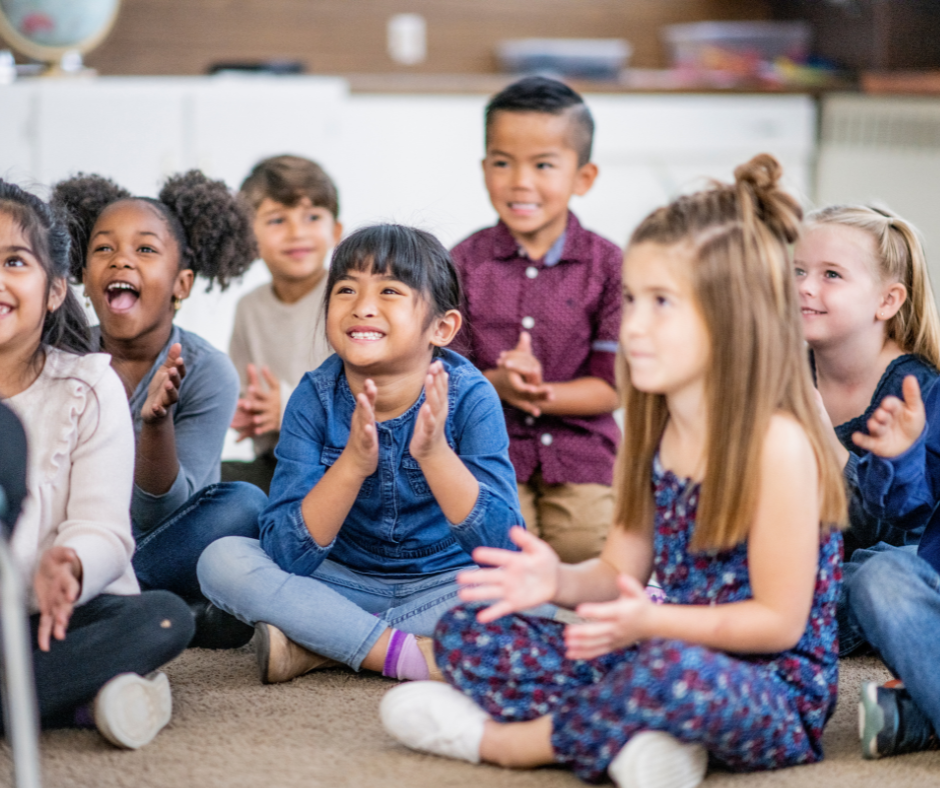 Kids on the classroom floor listening to teacher read