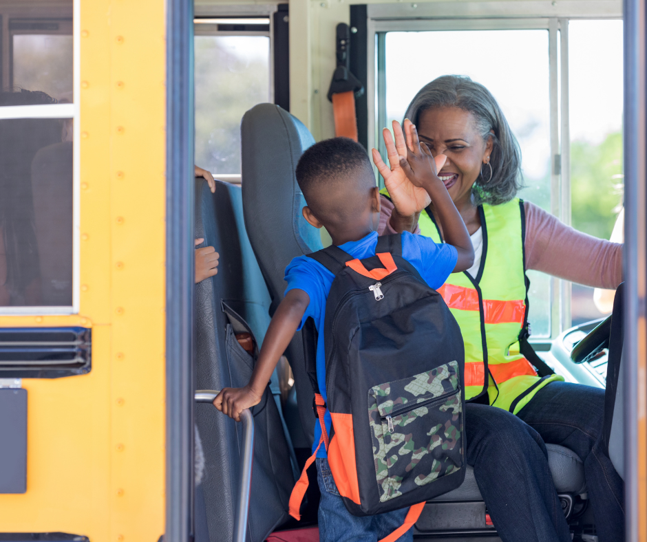 Student giving bus driver a high five