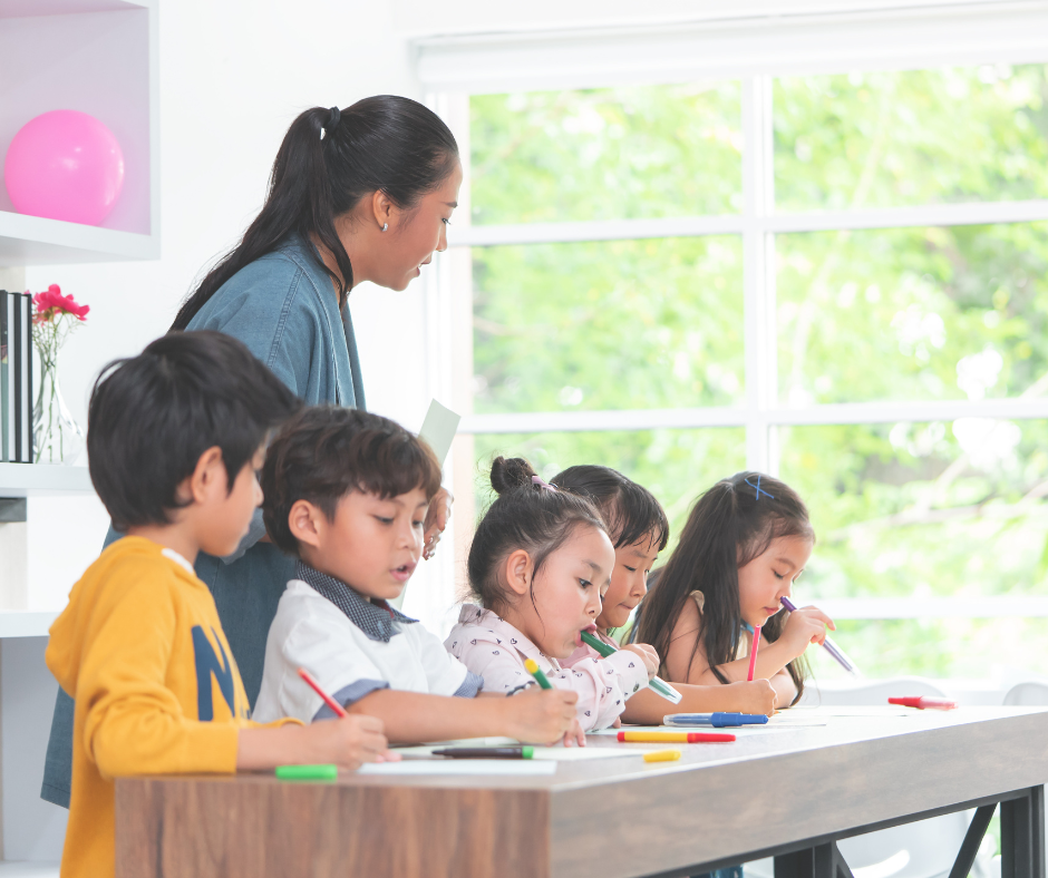 Teacher in class with students coloring