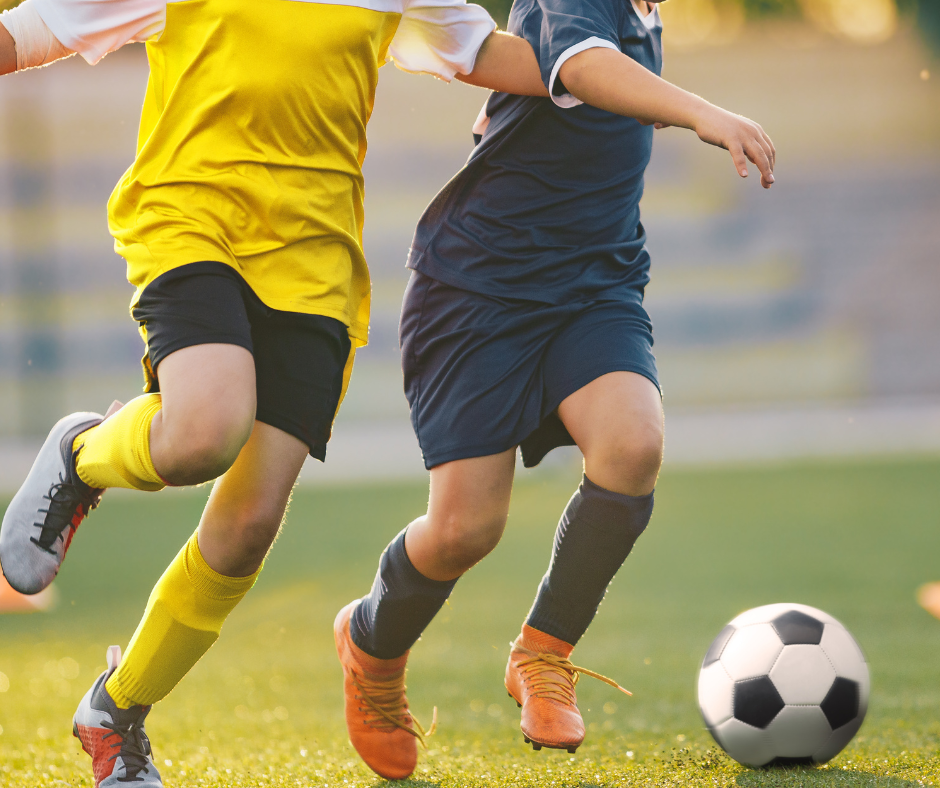 two kids playing soccer as after school activities