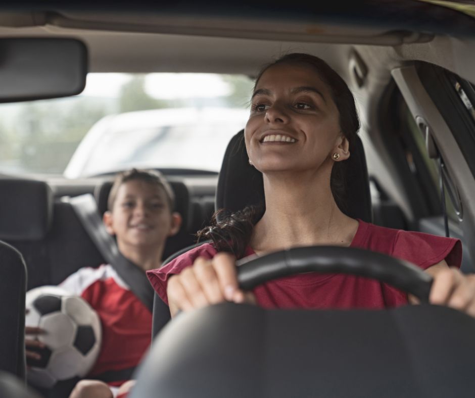 a parent looking in the backseat after dismissal to check on her kid